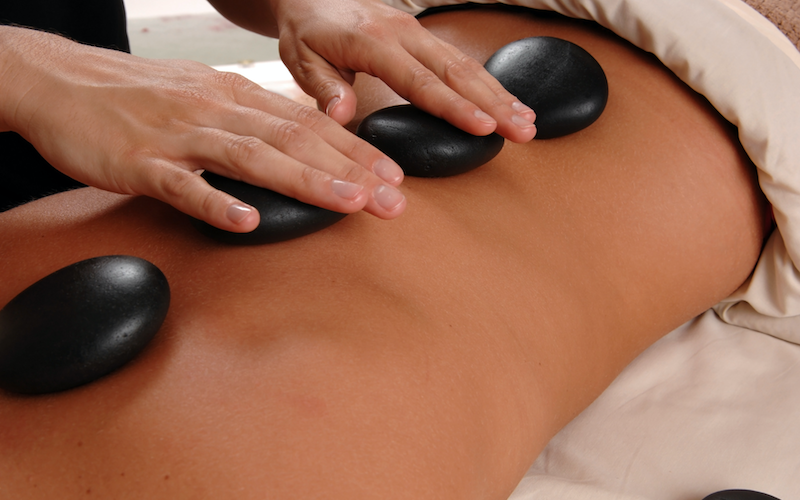 Warm up and unwind for $20 off with a toasty hot stone massage at Spring Retreat 